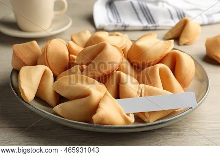 Tasty Fortune Cookies And Paper With Prediction On Wooden Table, Closeup. Space For Text