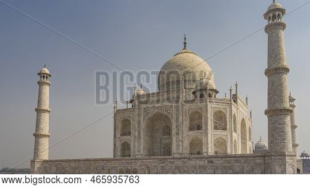 Beautiful Majestic Taj Mahal Against The Blue Sky. The Ancient Unique Mausoleum Made Of White Marble