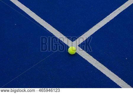 Ball Close To The Line On A Blue Paddle Tennis Court