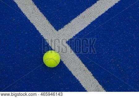 Ball Close To The Line On A Blue Paddle Tennis Court
