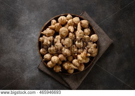 Jerusalem Artichoke Root, Sunchokes On Dark Brown.