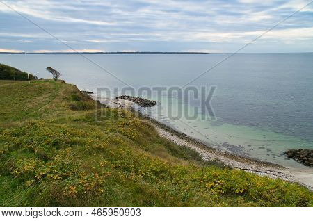 Hundested, Denmark On The Cliff Overlooking The Sea. Baltic Sea Coast, Grassy Meadow, Beach. Clouds 