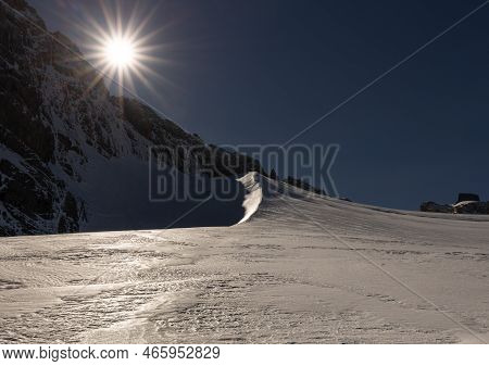 Dachstein Mountain Range On A Clear Sunny Day, With Harsh Shadows And Glistening Snow, Austria, Alps