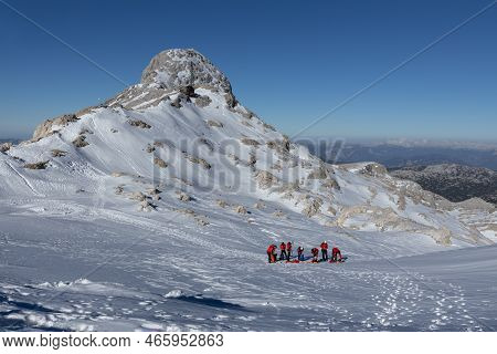 A Group Of Climbers Are Training On A Snowy Slope Near One Of The Peaks In The Dachstein Region, Aus