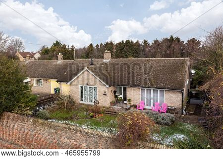 Fen Ditton, Cambridge, England - Feb 2 2019: Raised Imaged Of Single Storey Home Beyond High Wall Ta