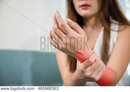 Closeup Hand. Asian Woman Hand Problem Injury Feeling Joint Pain, Young Female Sitting On Sofa Holds