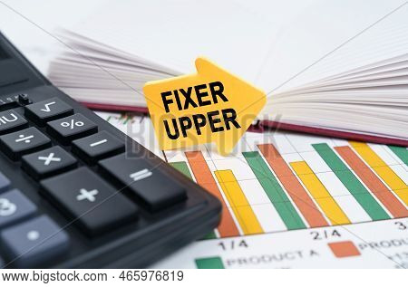 Business Concept. On The Business Charts There Is A Notepad, A Pen And An Arrow Sticker With The Ins