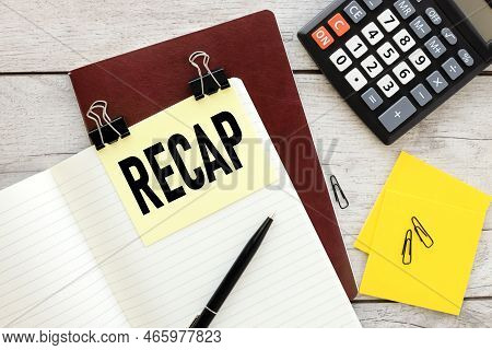 Recap Sticker On A Notebook With Text. Working Table