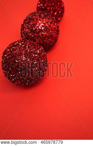 New Years, Christmas Decor, Red Shiny Balls On A Red Background. Flat Lay, Selectaive Focus