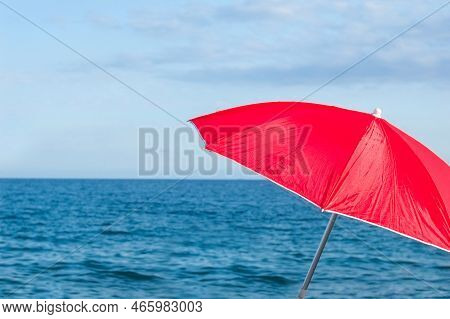 Red Parasol Umbrella On Tropical Island Beach. Colourful Sunshade In The Beach On Sunny Summer Day. 