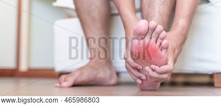 Man Having Barefoot Pain Due To Plantar Fasciitis And  Bunion Toes Or Blister Due To Wearing Narrow 