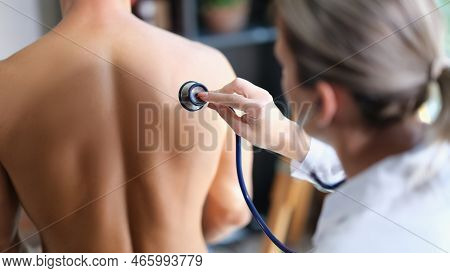 Close-up Of Female Doctor Examining Breath Of Patient Using Stethoscope. Man At Therapist Or Pulmono