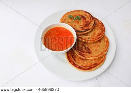 Paratha Bread Or Canai Bread Or Roti Maryam, Favorite Breakfast Dish. Served On Plate