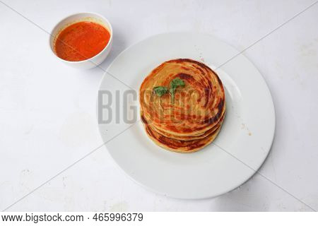 Paratha Bread Or Canai Bread Or Roti Maryam, Favorite Breakfast Dish. Served On Plate