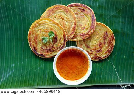 Paratha Bread Or Canai Bread Or Roti Maryam, Favorite Breakfast Dish. Served On Banana Leave