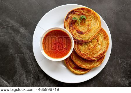 Paratha Bread Or Canai Bread Or Roti Maryam, Favorite Breakfast Dish. Served On Plate