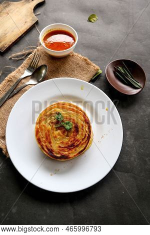 Paratha Bread Or Canai Bread Or Roti Maryam, Favorite Breakfast Dish. Served On Plate