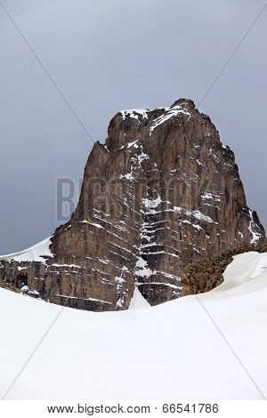 Snow Rocks And Gray Sky