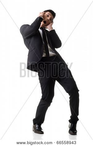 Asian business surprised with outrageously and funny pose, full length portrait isolated on white background.
