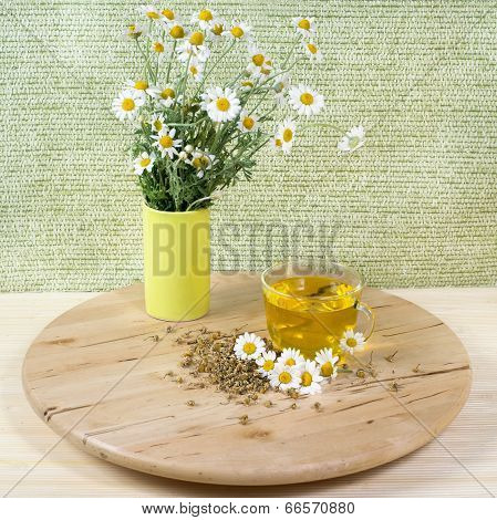 Tea with chamomile flowers