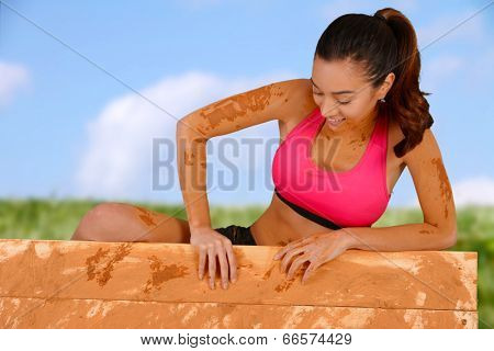 Woman competing in a mud run race