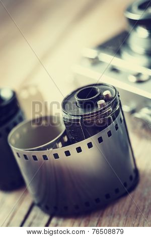 Old Photo Film Rolls, Cassette And Retro Camera On Background.