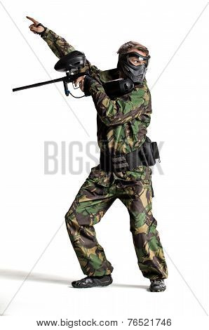 Painball player in action isolated