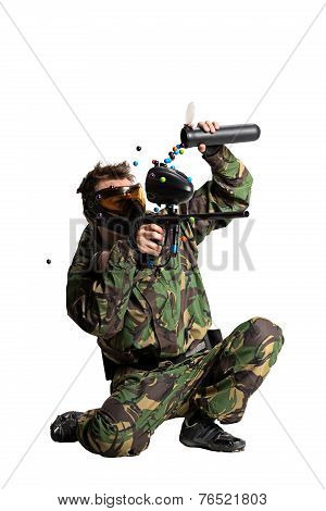 Painball player in action isolated