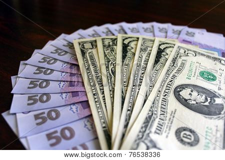 Dollars And Grivnas Banknotes On The Dark