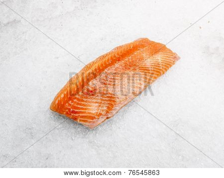 A Piece Of Salmon Fillet Is On Ice