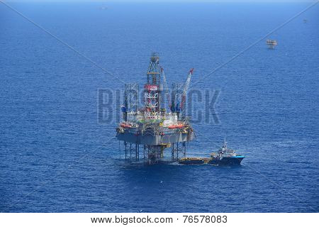 The Offshore Drilling Oil Rig And Supply Boat Side View