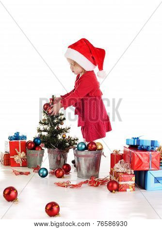 Little Santa Helper Decorating A Tree