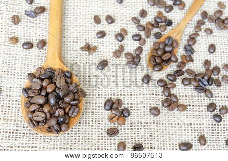 Big And Small Spoons Filled With Coffee Beans
