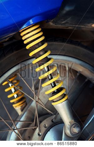 Shock Absorbers Of Yellow Motorcycles At The Park