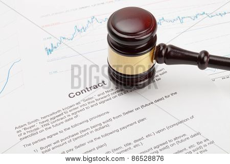 Wooden Judge's Gavel And Calculator Over Some Financial Documents