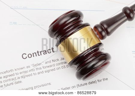 Wooden Judge's Gavel And Calculator Over Some Financial Documents