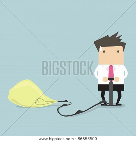 Businessman pumps up a balloon of a light bulb