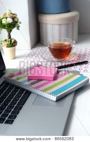 Laptop, notebook on windowsill. Working place concept