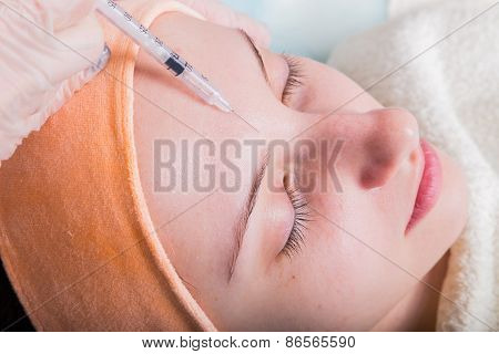 Subcutaneous injection into the girl's face.