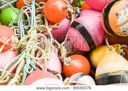 Close up of an old collection of brightly colored buoys on the Riverton jetty,