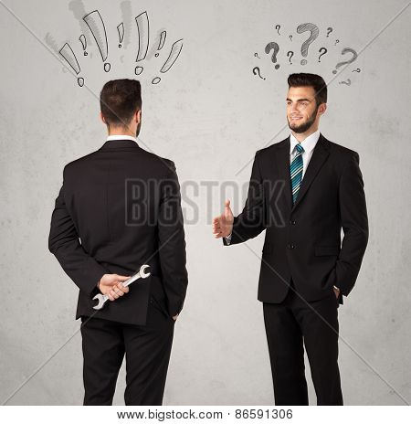 Ruthless businessman handshake with drawn exclamation and question marks around them head