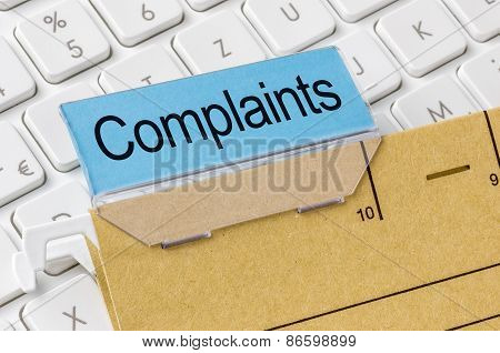 A Brown File Folder Labeled With Complaints