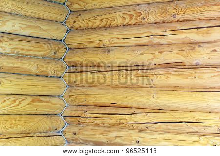 Corner Of The House Is Built From Wooden Logs And Entwined Rope