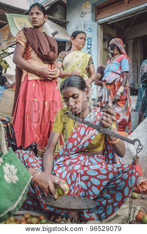 KAMALAPURAM, INDIA - 02 FABRUARY 2015: Indian lady sells vegetables on a market close to Hampi. Post-processed with grain, texture and colour effect.