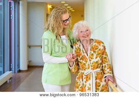 Medical Assistant Helping Happy Old Woman Walking