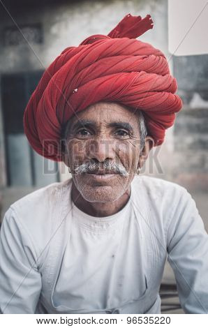 GODWAR REGION, INDIA - 12 FEBRUARY 2015: Rabari tribesman with traditional turban and clothes. Post-processed with grain, texture and colour effect.