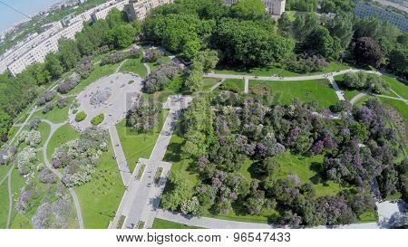 Lilac Garden with people at spring sunny day in Moscow. Aerial view