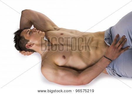 Handsome young bodybuilder laying down on the floor