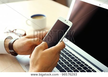 Man using mobile phone in office