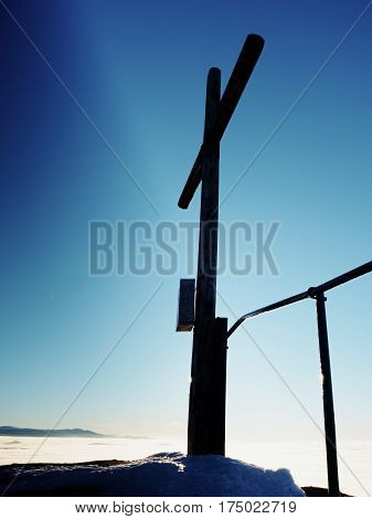 Winter Mountain. Wooden Cross On Rocky Mountain Summit.